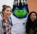 two students with Nico the Nighthawk